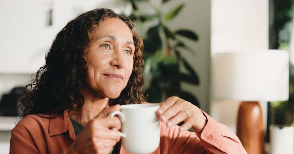 Midlife woman in soft natural light reflecting after a late ADHD diagnosis