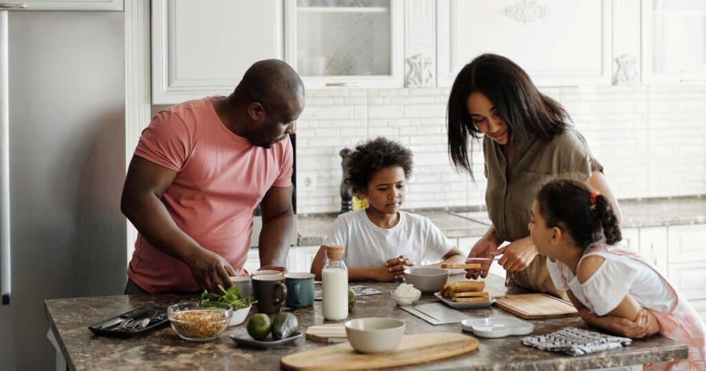 A family around a kitchen table looking relaxed and ready for their day enjoying their time together